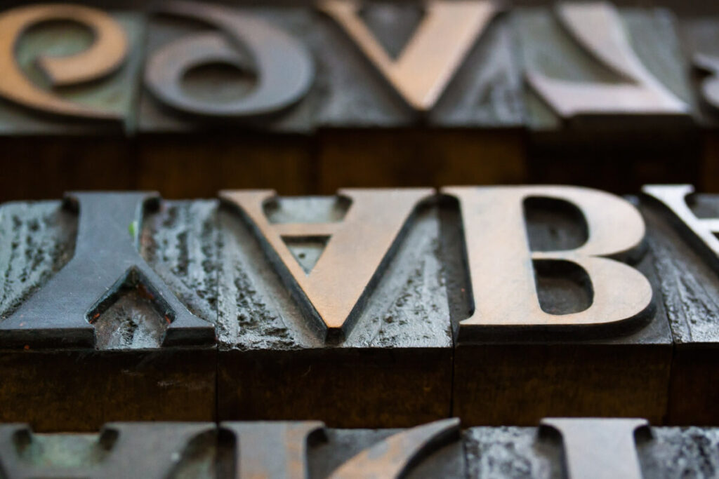 Example of a serif font. Metal letters of Y, A and B are upside down.